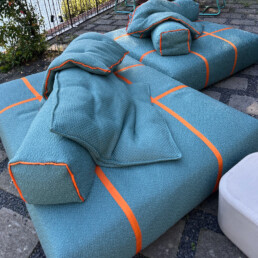 Baxter outdoor lounger in bright sky blue and deep orange on a patio at Lake Como
