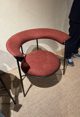 The new MDF ITalia Cantle occasional chair in a deep rhubarb colour with a circle base and curved slim back rest.