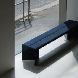 A bench sits window side in the Porro flagship store in Milan Italy.