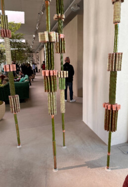 A cross between design and art, four floor-to-ceiling pillars with uniquely shaped pieces in shades of pink and green act as room dividers or space holders in the Paola Lenti flagship in Milan.