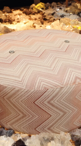 An up-close photo of an ottoman to highlight the fabric's angle pattern brought to life by Missoni.